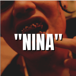 A person's mouth is adorned with golden grills on their teeth, with the product name "Nina" displayed in bold white text overlaying the image.