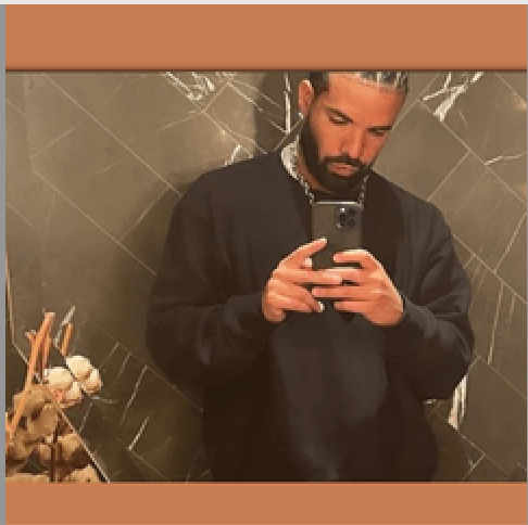 A man wearing a black sweater takes a mirror selfie with his smartphone in a tiled bathroom, contemplating productivity. He's surrounded by decorative items on the counter, and the photo is elegantly framed with a brown border, embodying the "Mind My Business" ethos.